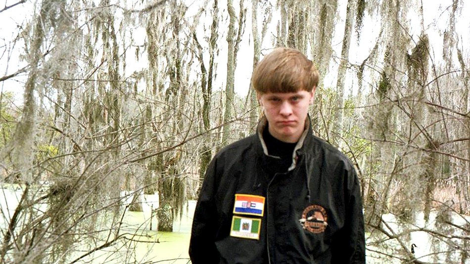 Dylann Roof wearing a jacket with two patches of an Apartheid era South African Flag and flag from the white ruled government of Rhodesia