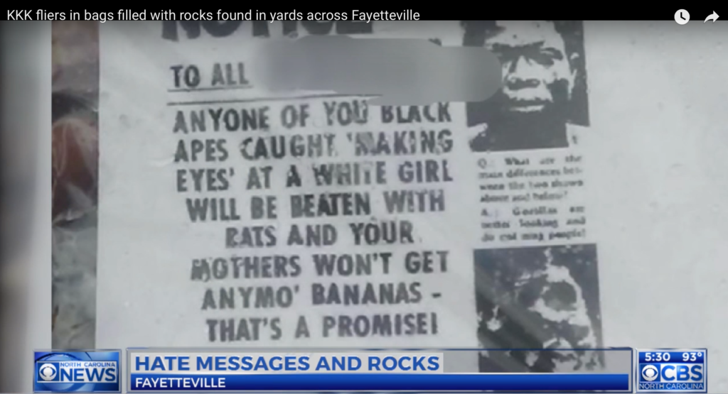 A screenshot of a CBS North Carolina news report showing a racist KKK flyer found in Fayetteville. The flyer contains hateful language targeting Black people and includes a photograph of a Black man.
