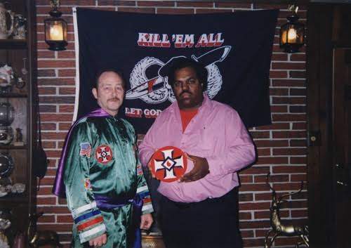 Davis with KKK leader Robert White. In the background is a banner that reads