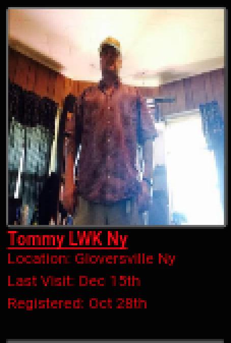 A low-resolution screenshot showing a profile for 'Tommy LWK Ny' from Gloversville, NY. The profile includes a photo of a man in a patterned shirt and a baseball cap standing in a room with wood-paneled walls.