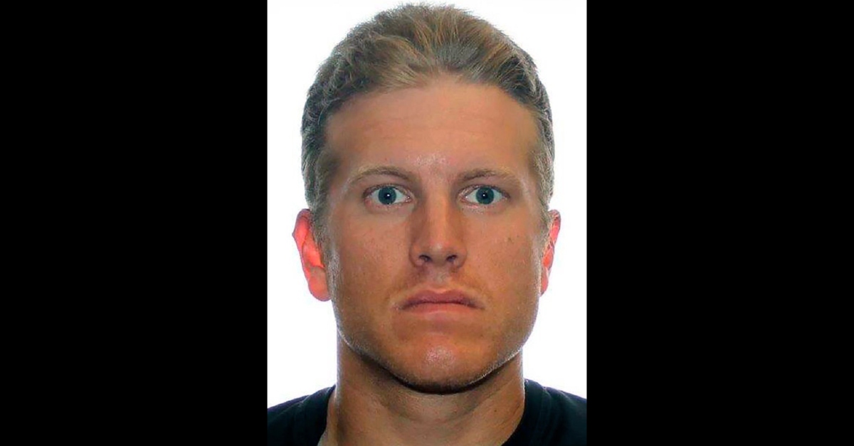 A headshot of a Caucasian man with short light-colored hair and blue eyes, looking directly at the camera against a white background.