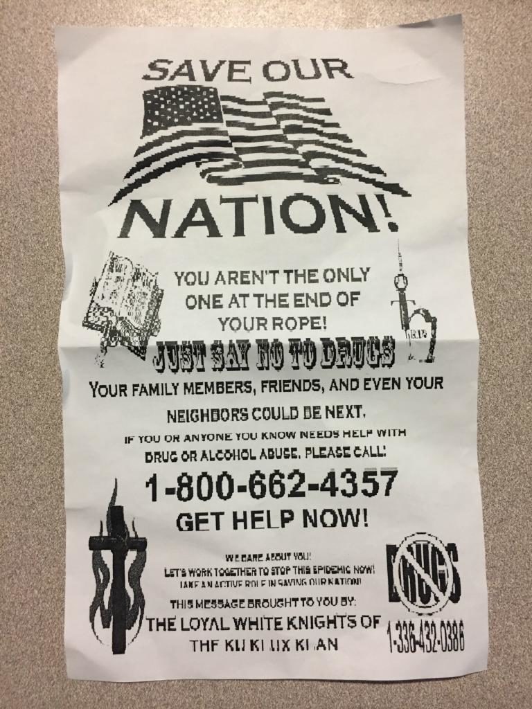A photograph of a KKK recruitment flyer titled 'SAVE OUR NATION!' featuring anti-drug messaging, a hotline number, and the name 'THE LOYAL WHITE KNIGHTS OF THE KU KLUX KLAN' at the bottom.