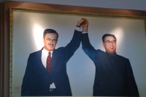 Syrian daddy Assad and North Korean Daddy Kim Il Sung A framed portrait of Syrian President Hafez al-Assad and North Korean leader Kim Il Sung holding their joined hands high in a sign of alliance.