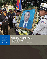 A Human Rights Watch report cover titled 'Tell Them That I Want to Kill Them': Two Decades of Impunity in Hun Sen's Cambodia. The cover features a photograph of Cambodian uniformed officers holding a large framed portrait of an Asian man in a suit.
