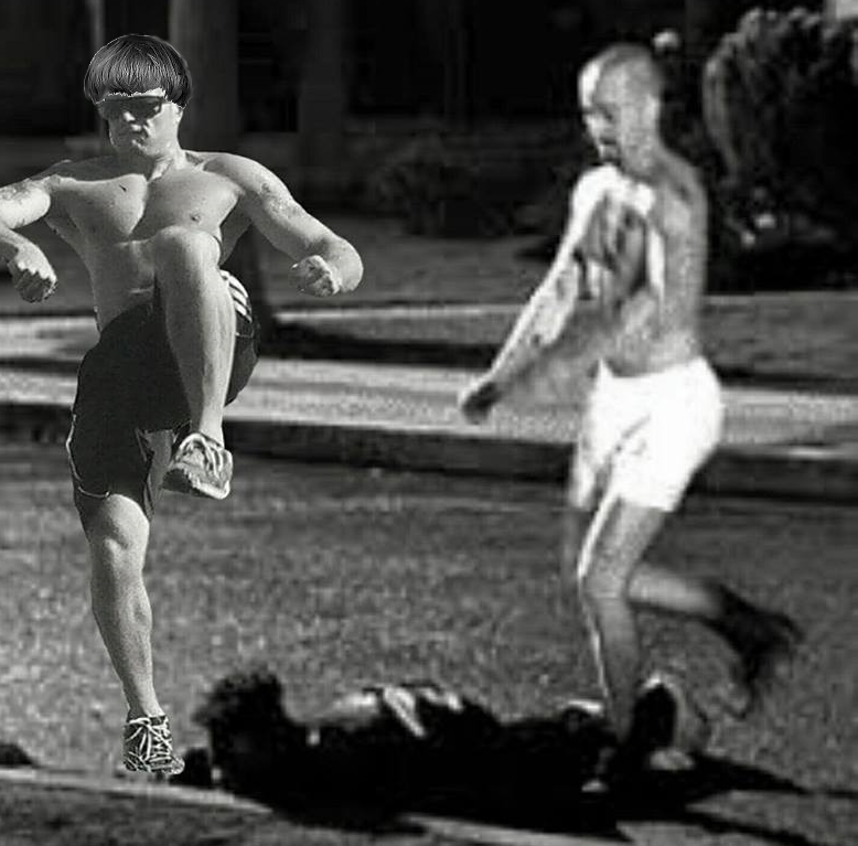 A black and white, edited photograph depicting two shirtless men in an outdoor setting. The man on the left, wearing dark shorts and sunglasses, is captured in a dynamic kicking motion and has a bowl-cut hairstyle digitally added to his head. A second, blurred man in white shorts is visible in the background, and a dark figure lies on the ground between them.