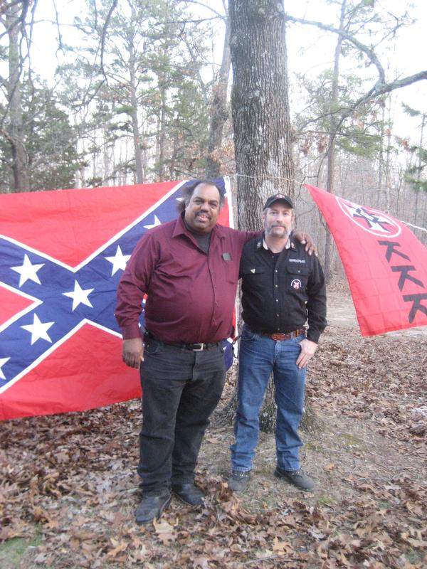 Daryl Davis (L) and KKK leader Frank Ancona (R) at Klan meeting, arm and arm