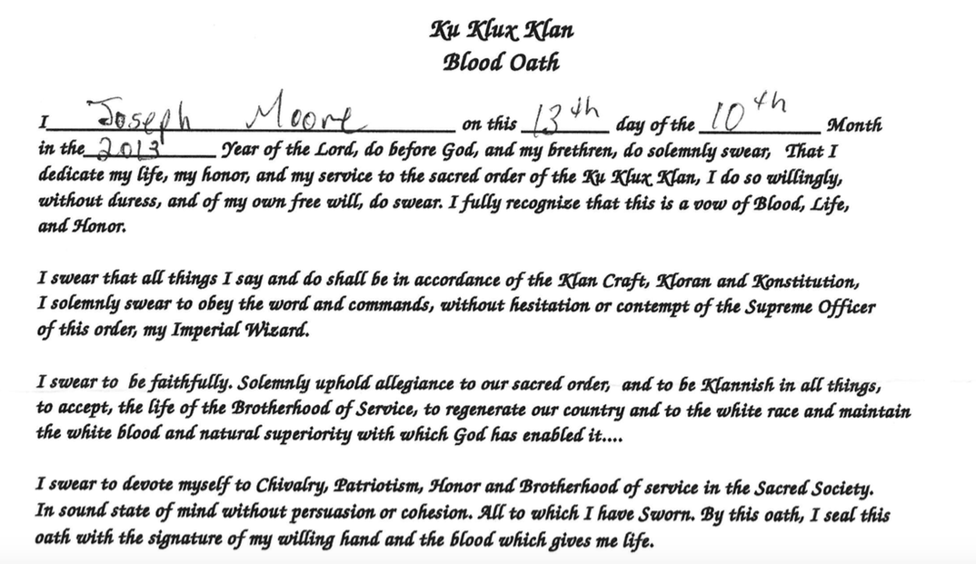 A document titled 'Ku Klux Klan Blood Oath' signed by Joseph Moore on October 13, 2013, pledging allegiance to the KKK.