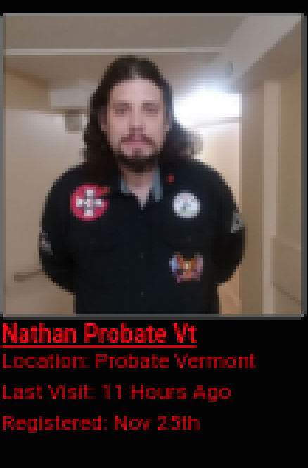 A screenshot of a profile for 'Nathan Probate Vt' featuring a photograph of a man with long dark hair and a beard wearing a black shirt with extremist patches. Text details his location in Vermont and recent activity.