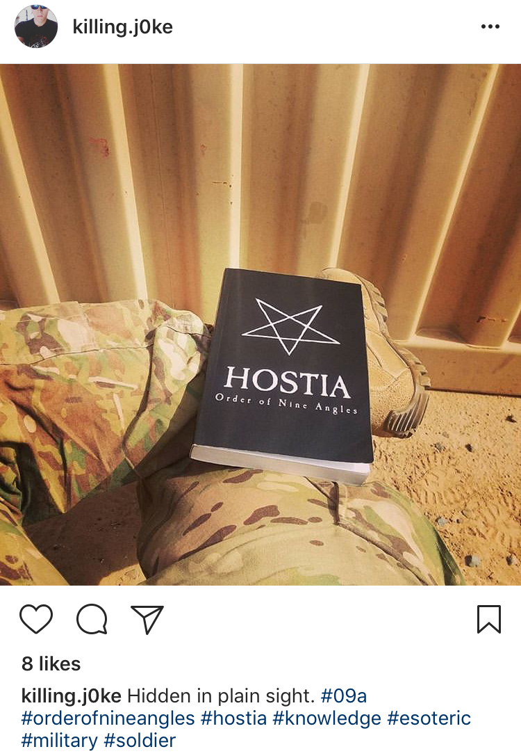 A screenshot of an Instagram post by user 'killing.j0ke' showing a person in military camouflage pants with a book titled 'HOSTIA Order of Nine Angles' resting on their lap. The caption includes hashtags related to the Order of Nine Angles and the military.