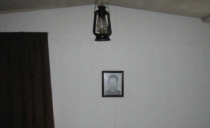 Picture of Pol Pot on the wall inside mobile home on secluded South Carolina property of the Rural People's Party (RPP) headquarters
