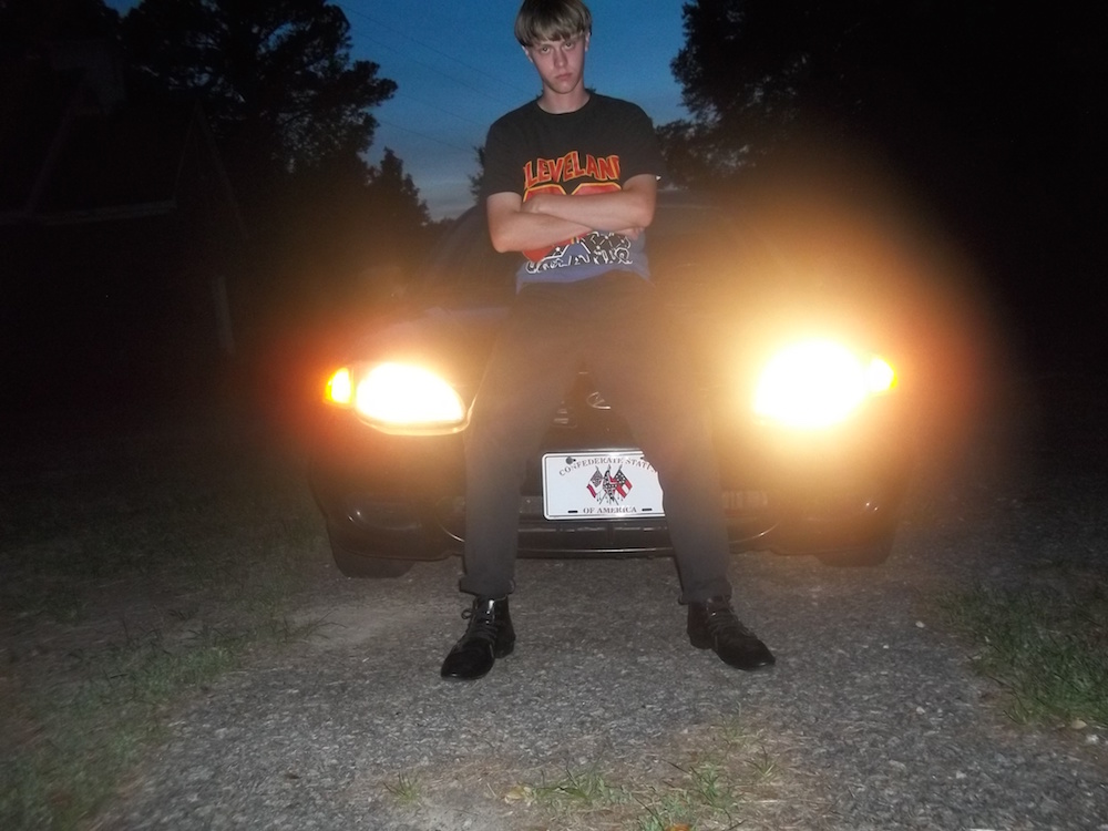 Photo of Dylann Roof. Note the license plate which depicts the confederate flag and reads