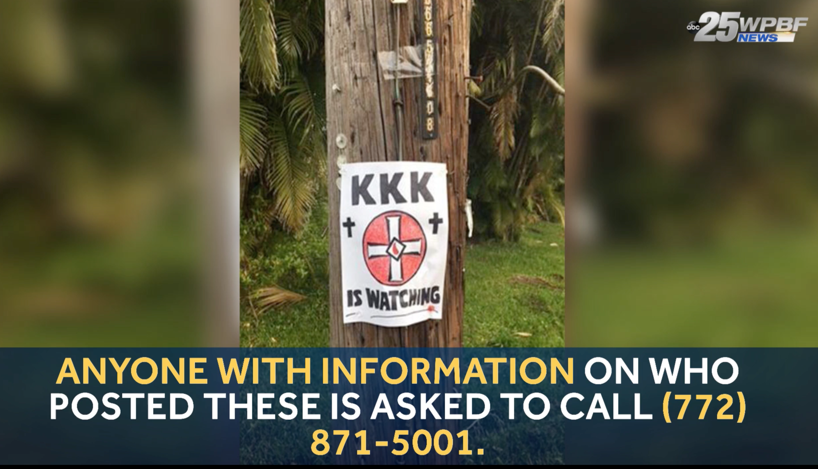A news broadcast screenshot showing a flyer posted on a wooden utility pole that reads 'KKK IS WATCHING' with a Klan symbol. A banner at the bottom asks for information regarding who posted it.